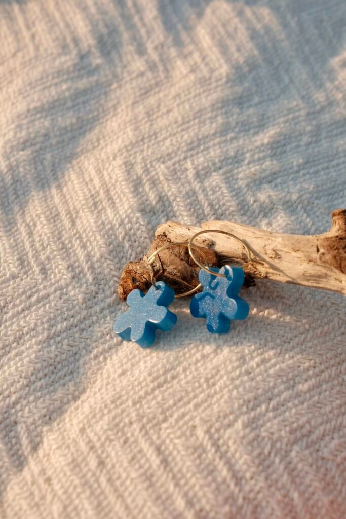 Handmade Mediterranean earrings on organic cotton towel— Hibiscus Amarillo Costa Brava photoshoot

