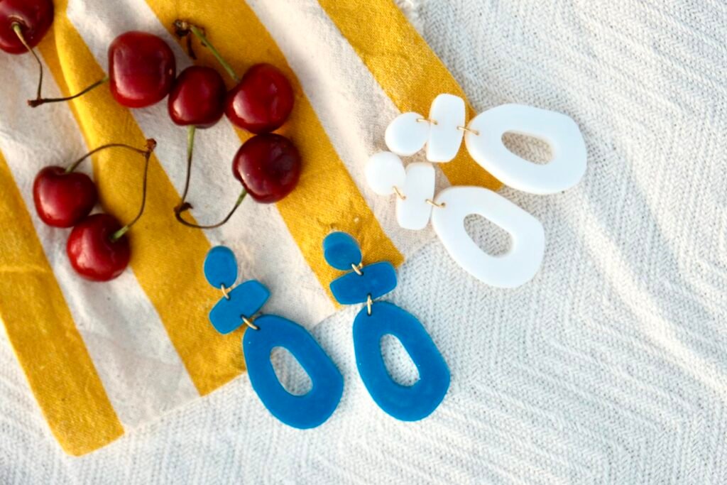Handmade Mediterranean earrings on organic cotton towel— Hibiscus Amarillo Costa Brava photoshoot
