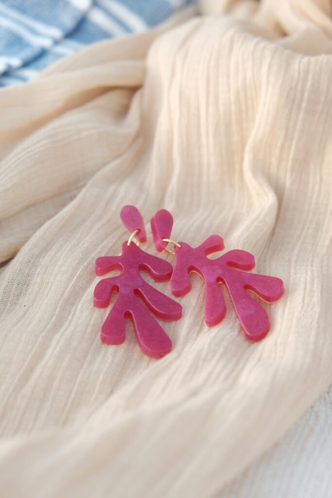 Handmade Mediterranean earrings on organic cotton towel— Hibiscus Amarillo Costa Brava photoshoot
